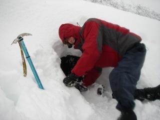 Building an emergency shelter in a snow drift