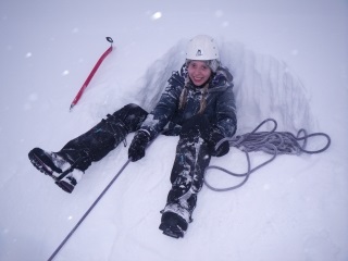 Stacey belaying in a bucket seat